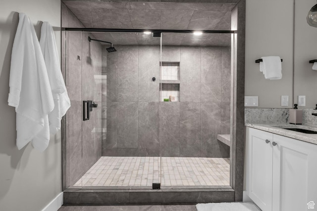 full bathroom featuring a shower stall and vanity