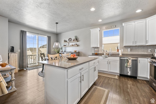 1879 N 925 E, North Ogden, UT 84414 - kitchen featuring stainless steel appliances, a textured ceiling, dark wood-type flooring, a sink, and decorative backsplash