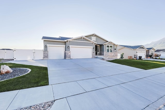 1879 N 925 E, North Ogden, UT 84414 - craftsman-style house featuring a gate, an attached garage, concrete driveway, and stone siding