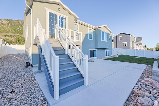 1879 N 925 E, North Ogden, UT 84414 - back of house with a patio, stucco siding, a residential view, and stairway