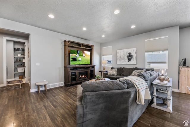 1879 N 925 E, North Ogden, UT 84414 - living area with wood finished floors, a textured ceiling, baseboards, and recessed lighting