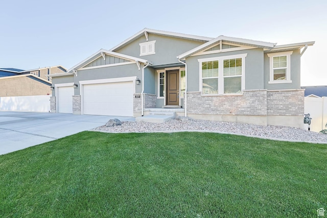 1879 N 925 E, North Ogden, UT 84414 - view of front of home featuring a garage, a front lawn, concrete driveway, and stucco siding