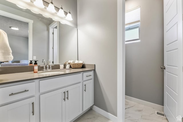 1879 N 925 E, North Ogden, UT 84414 - ensuite bathroom featuring marble look tiles, baseboards, and vanity