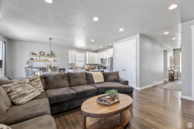 1879 N 925 E, North Ogden, UT 84414 - living room with dark wood finished floors, a textured ceiling, baseboards, and recessed lighting