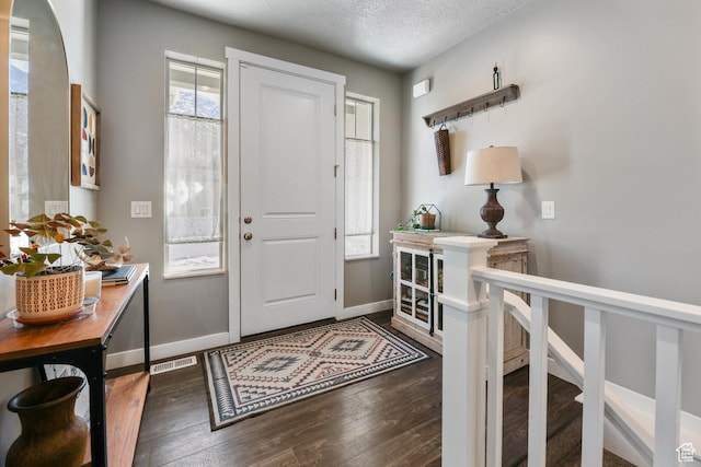 1879 N 925 E, North Ogden, UT 84414 - entrance foyer with dark wood-type flooring, baseboards, and a textured ceiling