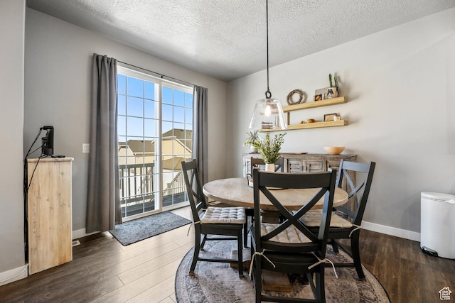 1879 N 925 E, North Ogden, UT 84414 - dining space featuring wood finished floors, a textured ceiling, and baseboards