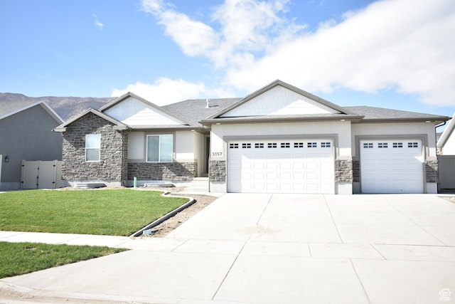 130 S Liberty St Unit 203, Grantsville, UT 84029 - view of front of home featuring an attached garage, stucco siding, a front lawn, concrete driveway, and stone siding