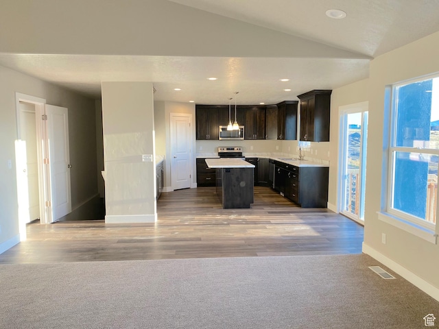 130 S Liberty St Unit 203, Grantsville, UT 84029 - kitchen with visible vents, a sink, a center island, appliances with stainless steel finishes, and vaulted ceiling