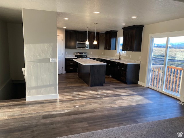 130 S Liberty St Unit 203, Grantsville, UT 84029 - kitchen featuring light countertops, a kitchen island, dark wood-style flooring, and stainless steel appliances