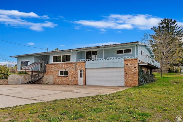 405 W 5100 S, Washington Terrace, UT 84405 - view of front of home featuring a garage, a front yard, brick siding, and driveway