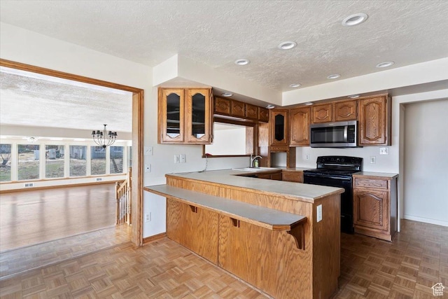 445 W 5100 S, Washington Terrace, UT 84405 - kitchen with stainless steel microwave, glass insert cabinets, electric range, and plenty of natural light
