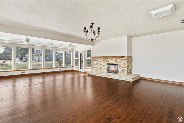 445 W 5100 S, Washington Terrace, UT 84405 - unfurnished living room with hardwood / wood-style flooring, a healthy amount of sunlight, a fireplace, and ceiling fan with notable chandelier
