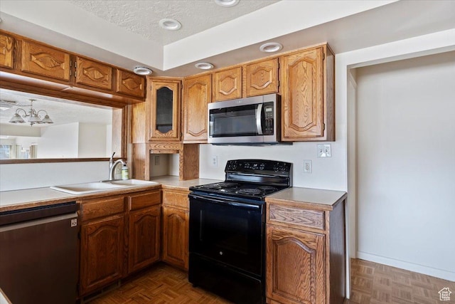 445 W 5100 S, Washington Terrace, UT 84405 - kitchen with a sink, a textured ceiling, appliances with stainless steel finishes, brown cabinetry, and light countertops