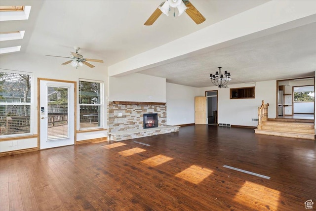 445 W 5100 S, Washington Terrace, UT 84405 - unfurnished living room with a stone fireplace, a skylight, ceiling fan with notable chandelier, and hardwood / wood-style floors