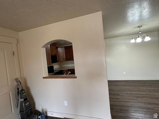 1045 S 1700 W Unit 1121, Payson, UT 84651 - interior space featuring baseboards, arched walkways, dark wood finished floors, a textured ceiling, and a notable chandelier