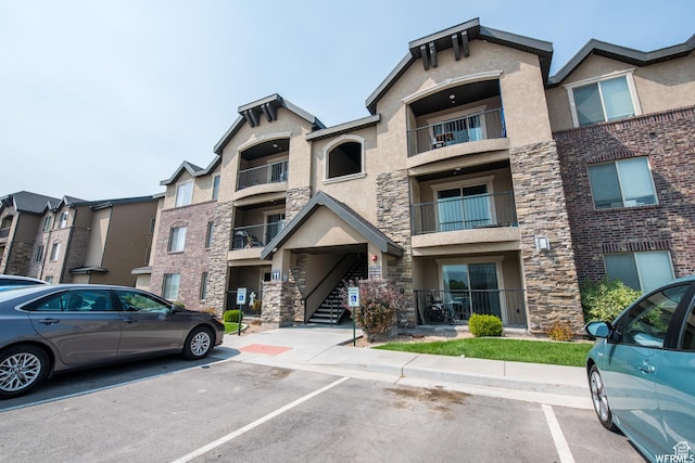 view of building exterior featuring uncovered parking