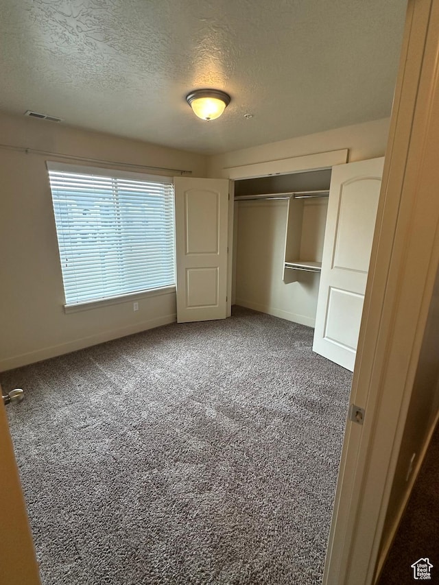 1045 S 1700 W Unit 1121, Payson, UT 84651 - unfurnished bedroom featuring baseboards, visible vents, a textured ceiling, carpet floors, and a closet