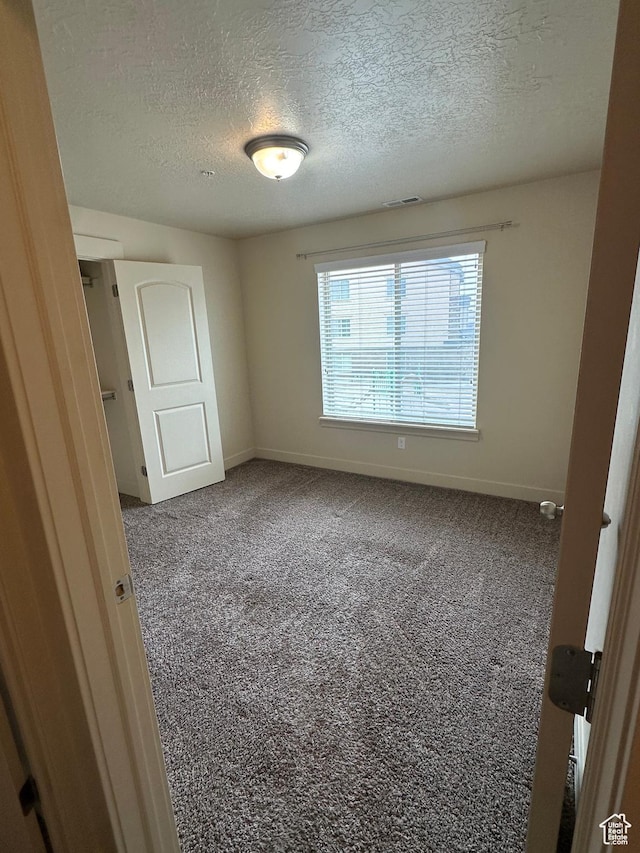 1045 S 1700 W Unit 1121, Payson, UT 84651 - unfurnished bedroom featuring carpet, baseboards, and a textured ceiling