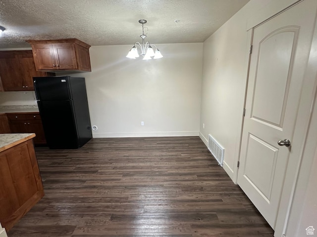 1045 S 1700 W Unit 1121, Payson, UT 84651 - kitchen featuring light countertops, visible vents, an inviting chandelier, dark wood-type flooring, and freestanding refrigerator