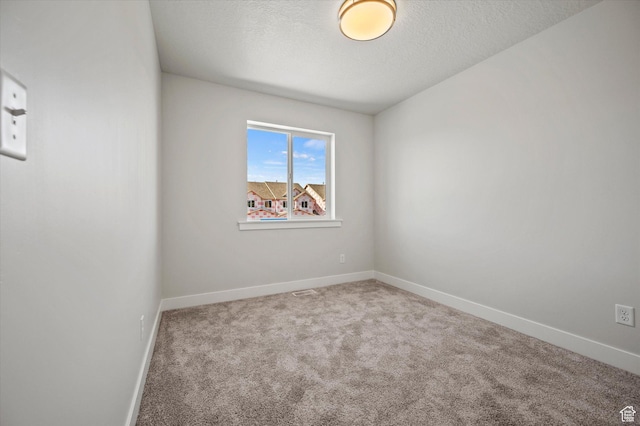 635 S 85 E Unit 26, Smithfield, UT 84335 - empty room featuring baseboards, a textured ceiling, and carpet flooring