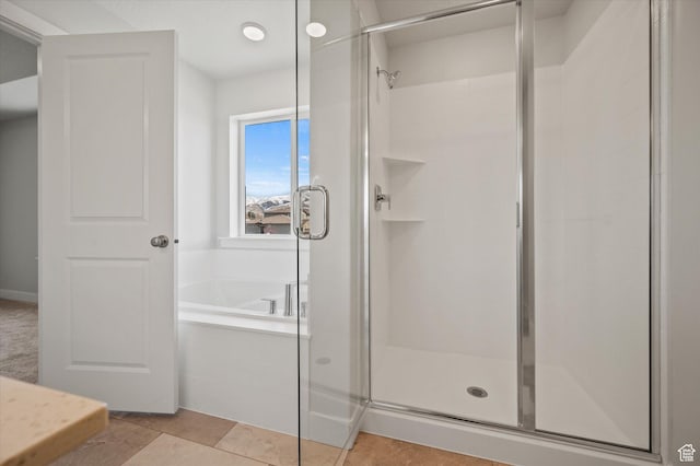 635 S 85 E Unit 26, Smithfield, UT 84335 - bathroom featuring tile patterned flooring, a shower stall, and a garden tub