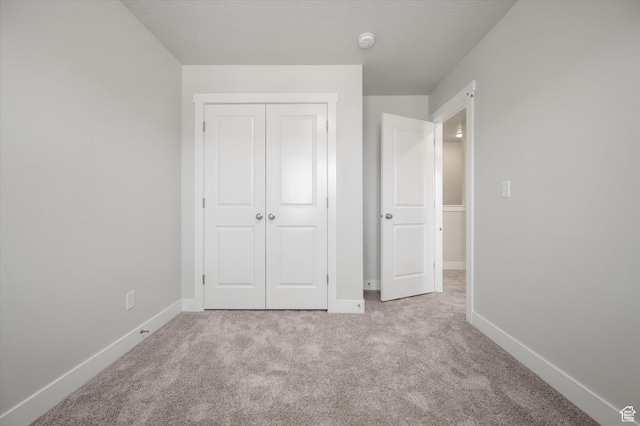 635 S 85 E Unit 26, Smithfield, UT 84335 - unfurnished bedroom featuring carpet, a closet, and baseboards
