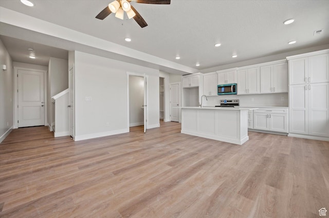 635 S 85 E Unit 26, Smithfield, UT 84335 - kitchen featuring a sink, light countertops, appliances with stainless steel finishes, white cabinetry, and light wood-type flooring