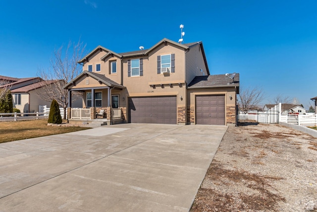 1114 Alexander Ct, Grantsville, UT 84029 - view of front of property featuring stucco siding, a porch, fence, a garage, and stone siding
