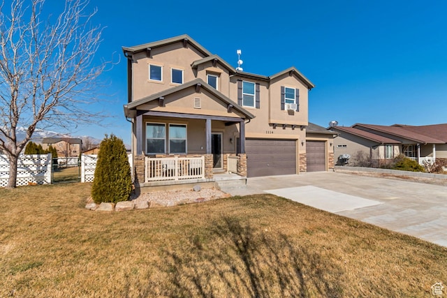 1114 Alexander Ct, Grantsville, UT 84029 - view of front of property with driveway, stone siding, an attached garage, a porch, and stucco siding