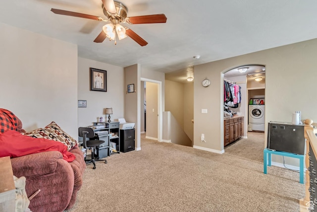 1114 Alexander Ct, Grantsville, UT 84029 - home office featuring light carpet, baseboards, arched walkways, a ceiling fan, and washer / clothes dryer