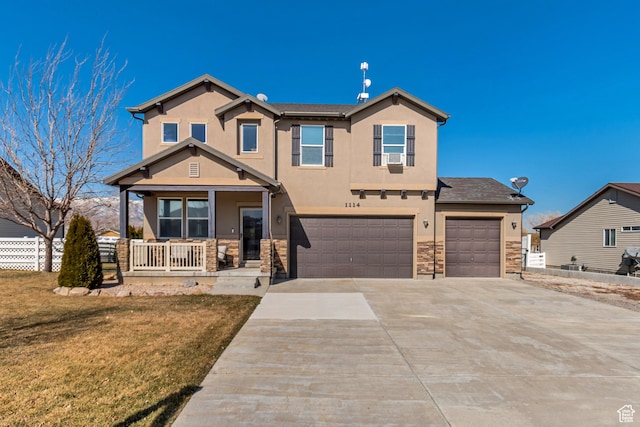 1114 Alexander Ct, Grantsville, UT 84029 - view of front of property with stucco siding, covered porch, concrete driveway, fence, and stone siding
