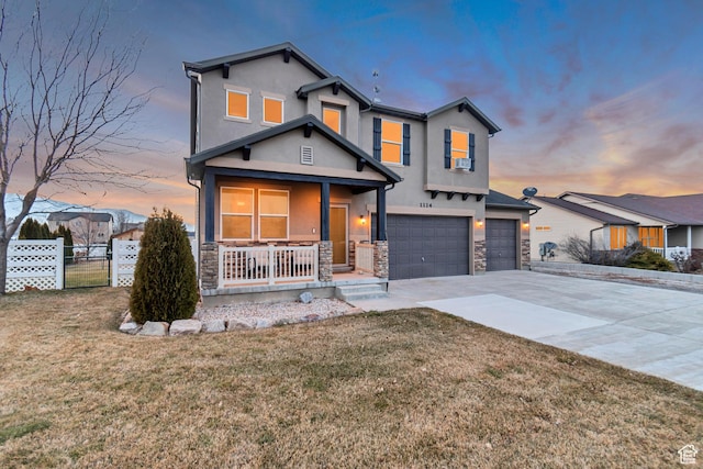 1114 Alexander Ct, Grantsville, UT 84029 - traditional-style home with stucco siding, a porch, fence, stone siding, and driveway