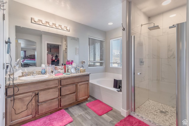 1114 Alexander Ct, Grantsville, UT 84029 - bathroom featuring a garden tub, a shower stall, a sink, and wood finished floors