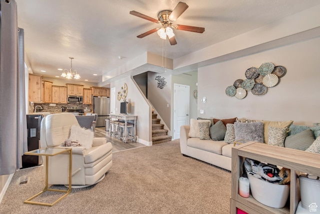 1114 Alexander Ct, Grantsville, UT 84029 - living room featuring recessed lighting, ceiling fan with notable chandelier, light carpet, baseboards, and stairs