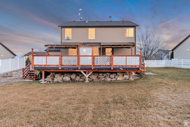 1114 Alexander Ct, Grantsville, UT 84029 - back of property at dusk with a fenced backyard, a lawn, and a deck