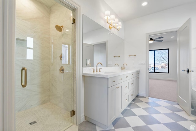 full bathroom featuring double vanity, a stall shower, a sink, and tile patterned floors