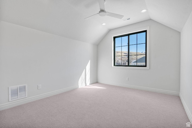 additional living space featuring lofted ceiling, carpet flooring, visible vents, and baseboards