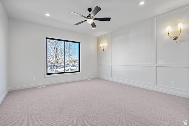 spare room with baseboards, recessed lighting, a ceiling fan, and light colored carpet
