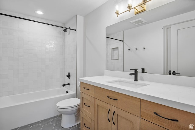 full bathroom featuring toilet, visible vents, bathing tub / shower combination, vanity, and tile patterned floors