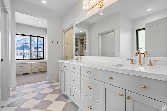 bathroom with double vanity, recessed lighting, a sink, and tile patterned floors