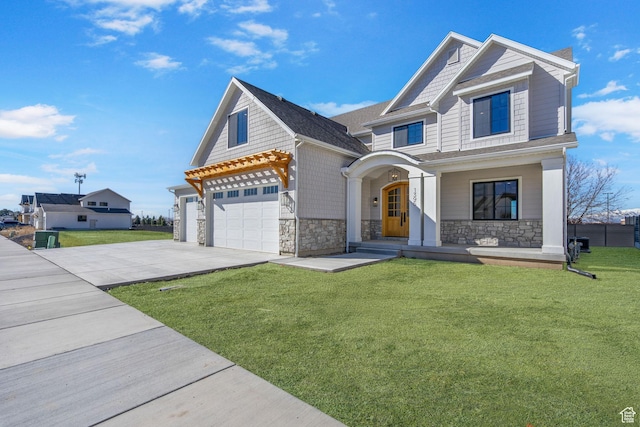 view of front of property featuring an attached garage, concrete driveway, a front lawn, and stone siding