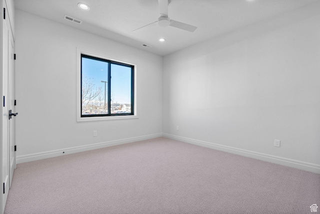 unfurnished room featuring light carpet, baseboards, and visible vents