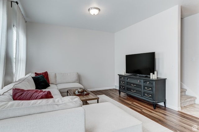 1424 W Stone Meadow Dr, West Jordan, UT 84088 - living room featuring dark wood-style floors, stairway, and baseboards