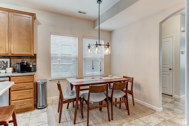 1424 W Stone Meadow Dr, West Jordan, UT 84088 - dining room with arched walkways, visible vents, and baseboards