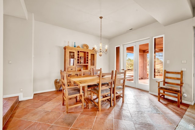1657 N Kayenta Dr, Ivins, UT 84738 - dining area with stone tile flooring, baseboards, and a chandelier