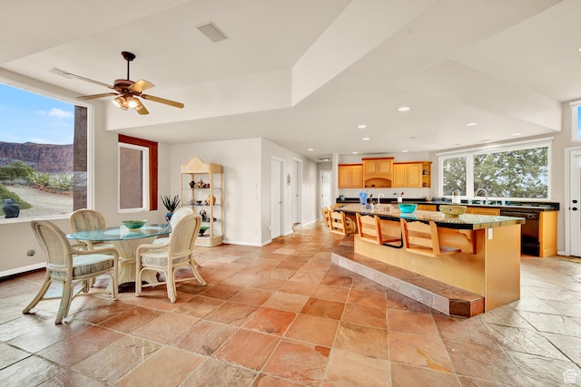 1657 N Kayenta Dr, Ivins, UT 84738 - kitchen with stone tile flooring, a sink, dishwasher, a breakfast bar, and baseboards