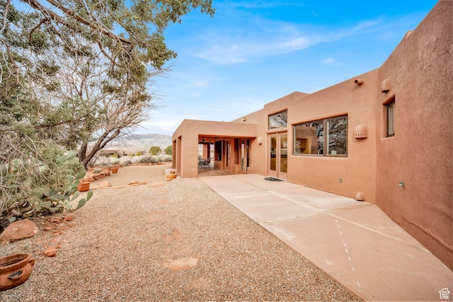 1657 N Kayenta Dr, Ivins, UT 84738 - rear view of house with stucco siding and a patio area