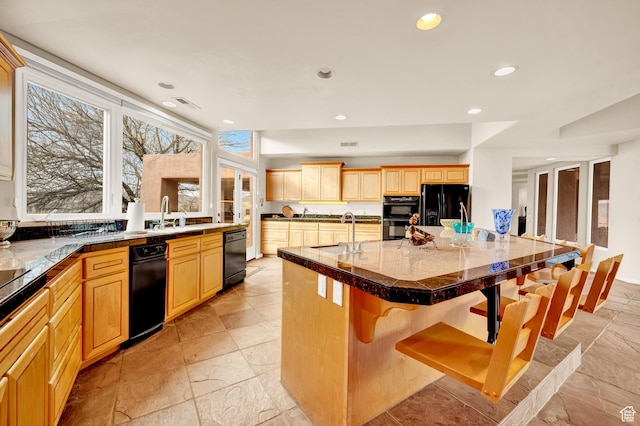 1657 N Kayenta Dr, Ivins, UT 84738 - kitchen featuring black appliances, a sink, healthy amount of natural light, recessed lighting, and a kitchen bar