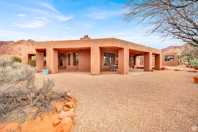 1657 N Kayenta Dr, Ivins, UT 84738 - rear view of property featuring a ceiling fan, a patio, stucco siding, and a mountain view