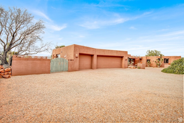1657 N Kayenta Dr, Ivins, UT 84738 - garage featuring a gate and gravel driveway